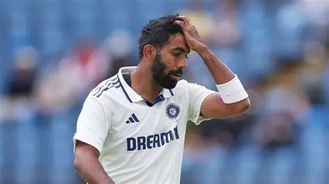 Jasprit Bumrah holding his head in Indian Test whites after a costly over