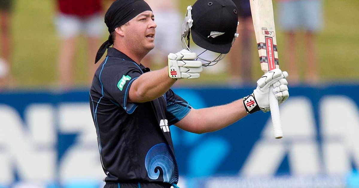 Jesse Ryder in New Zealand kit raising his bat and helmet to celebrate a century